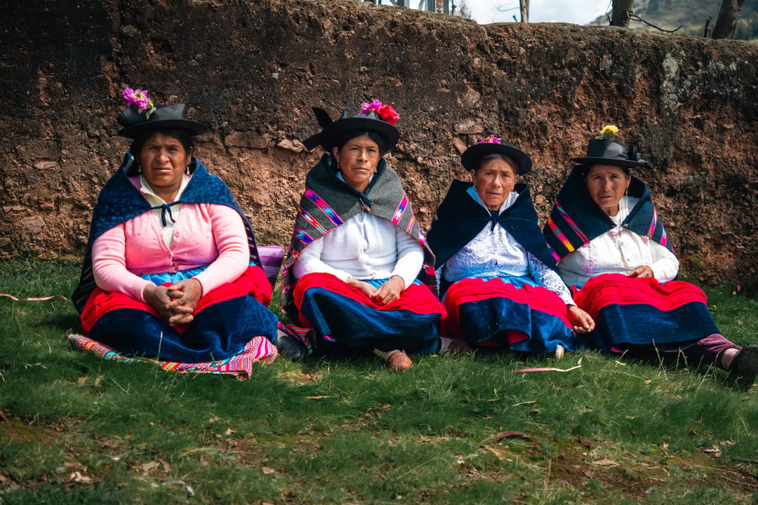 Four women from the Aymara farming community in traditional dress at the El Origen potato producers meeting near Huancayo, Peru.