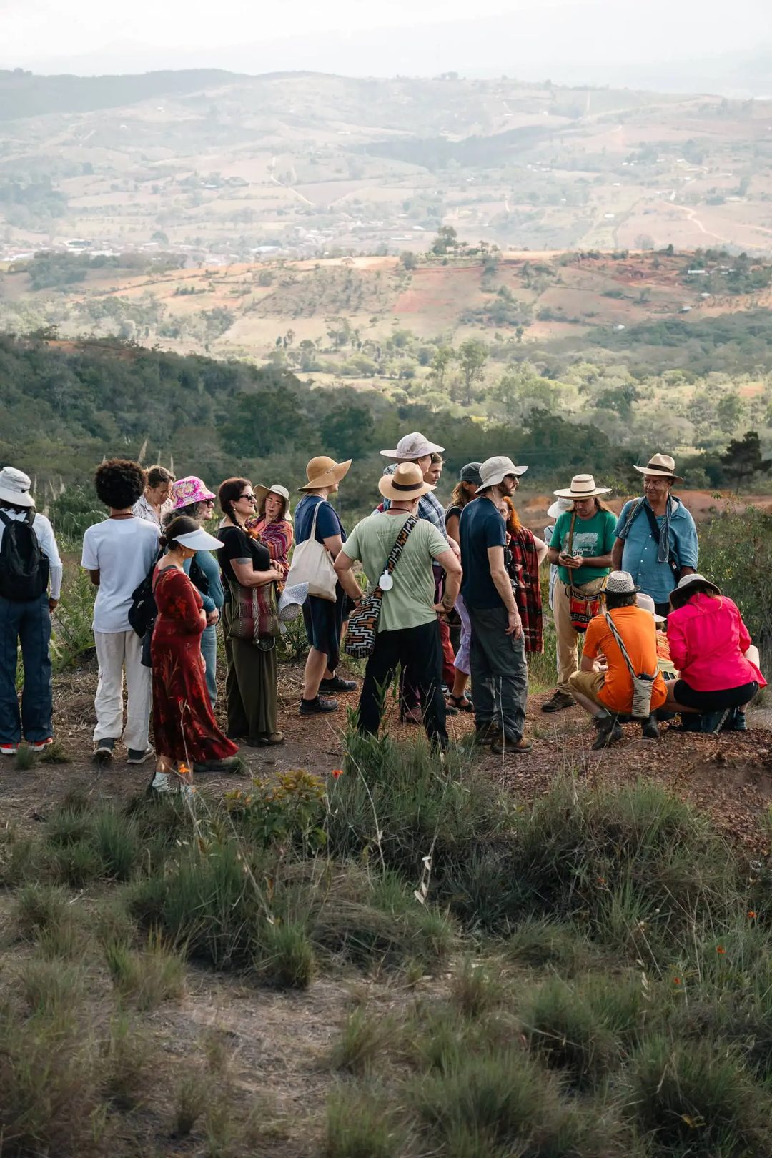A group gathers on a hillside overlooking the rural landscape around Barichara.